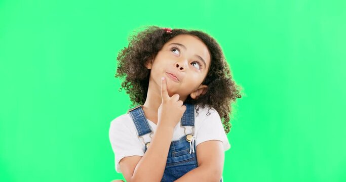Thinking, green screen and a child with a decision isolated on a studio background. Doubt, think and a confused girl kid looking thoughtful, contemplating and planning an idea with mockup space