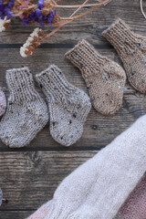 Fototapeta na wymiar Small, chunky and warm baby socks, made of thick cotton yarn
