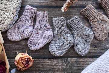 Fototapeta na wymiar Small, chunky and warm baby socks, made of thick cotton yarn