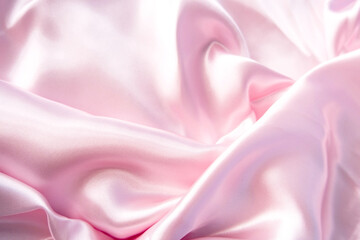 Abstract background of luxury pastel pink fabric, folded textile or liquid wave or wavy folds silk...