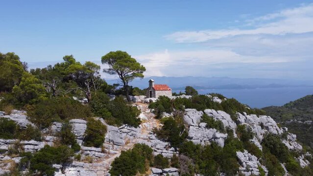 Experience the beauty of St. Elijah's Church on Mljet Island with stunning drone footage. Admire unique Croatian architecture and scenic views of the Adriatic Sea.