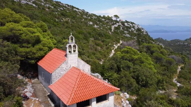 Experience the beauty of St. Elijah's Church on Mljet Island with stunning drone footage. Admire unique Croatian architecture and scenic views of the Adriatic Sea.
