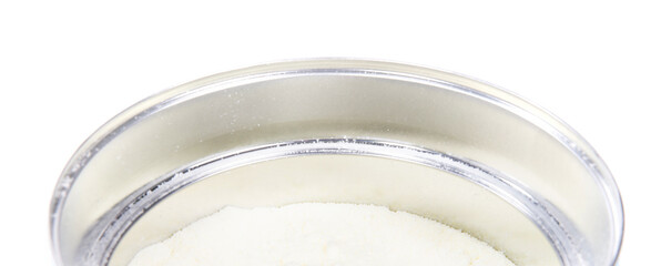 Baby milk powder in can that is open, with a spoon