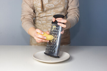 Girl grates potatoes with a grater