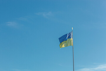 Ukrainian flag against the blue sky