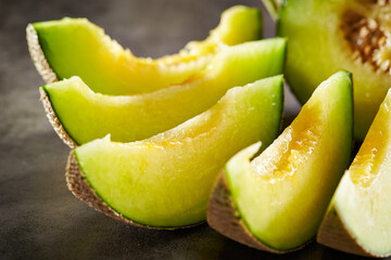 slices of melon on a dark background