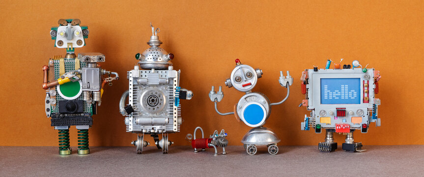 Four steampunk toy robots and small dog. Metal copper silver texture characters lined up in a row. A group of robots of different height, color, style and material