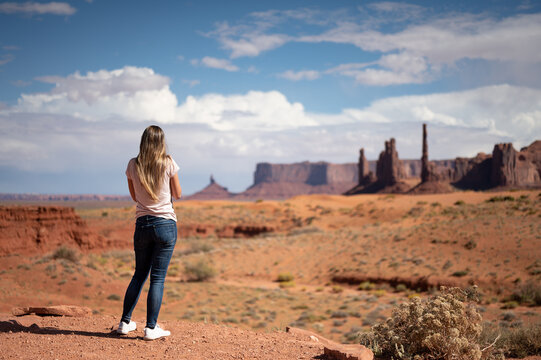 Young girl taking photos in the desert of Monument Valley