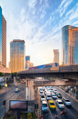 Fototapeta na wymiar Train in motion blur in business downtown, modern city of skyscrapers