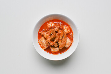 Korean home cooked pork kimchi stew dish on white background