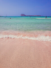 Fototapeta na wymiar The pink sand and the turquoise water at the beach of Balos Lagoon, Crete island, Greece