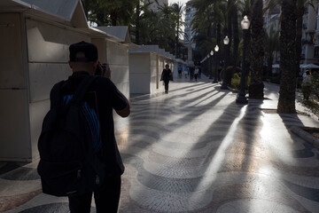 boy taking pictures on a esplanade