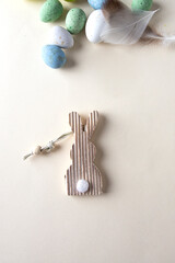 Easter minimalist flat lay composition with easter bunny,wood with different color eggs.