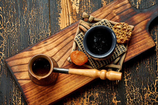 Turkish coffee in a cezve with a cup and oriental delicacies