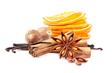 Dry oranges with  cinnamon, nutmeg, anise  and vanilla on white background closeup. Citrus slices...