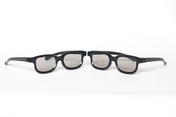two glasses for watching stereo movies. on a white background. front view. selective focus on the middle of the frames