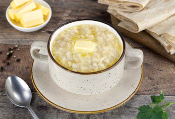 Traditional Armenian porridge - harissa cooked with chicken, wheat, butter and lavash. Wooden background. 
