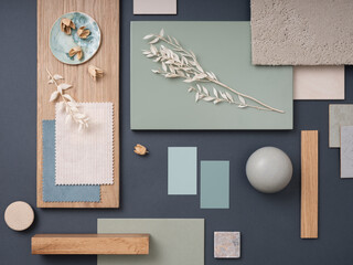 Elegant  flat lay composition in green, blue and beige color palette with textile and paint samples, lamella panels and tiles. Architect and interior designer moodboard. Top view. Copy space.