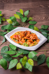 wok fried red sweet and sour spicy sauce with big prawn and cucumber in plate on wood table asian chinese halal food banquet menu for restaurant