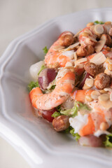 chilled cold big prawn salad with mixed fresh fruit in sesame sauce and garlic nuts on wood table chinese asian halal banquet seafood menu