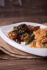 two in one varieties wok fried big prawn with nonya sweet and sour dark sauce and cereal butter prawn with curry leaf on wood table chinese halal banquet seafood menu