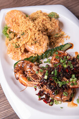 two in one varieties wok fried big prawn with nonya sweet and sour dark sauce and cereal butter prawn with curry leaf on wood table chinese halal banquet seafood menu