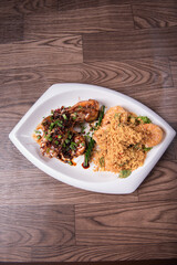 two in one varieties wok fried big prawn with nonya sweet and sour dark sauce and cereal butter prawn with curry leaf on wood table chinese halal banquet seafood menu