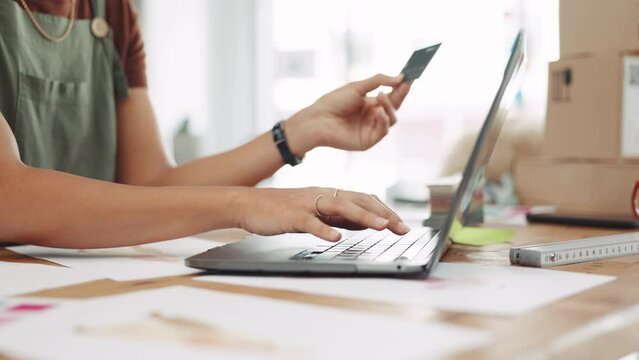Woman, laptop and hands with credit card for ecommerce, small business or online shopping at workshop. Hand of female fashion designer wireless purchase, transaction or internet banking on computer