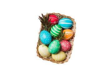 Basket of colorful Easter eggs isolated on white background. Easter basket filled with colored eggs top view holiday concept