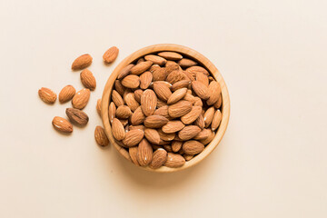 Fresh healthy Almond in bowl on colored table background. Top view