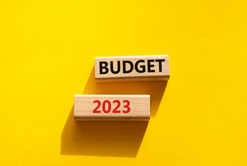 Budget 2023 symbol. Wooden blocks with words Budget 2023. Beautiful yellow background. Business and Budget 2023 concept. Copy space.