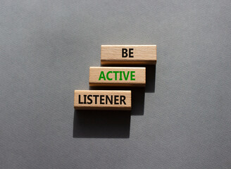 Be active listener symbol. Wooden blocks with words Be active listener. Beautiful grey background. Business and active listening concept. Copy space.