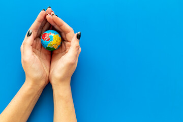 Female hands holding globe. Save the Earth planet ecology concept.