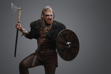 Fototapeta na wymiar Studio shot of isolated on gray background furious barbarian from north.