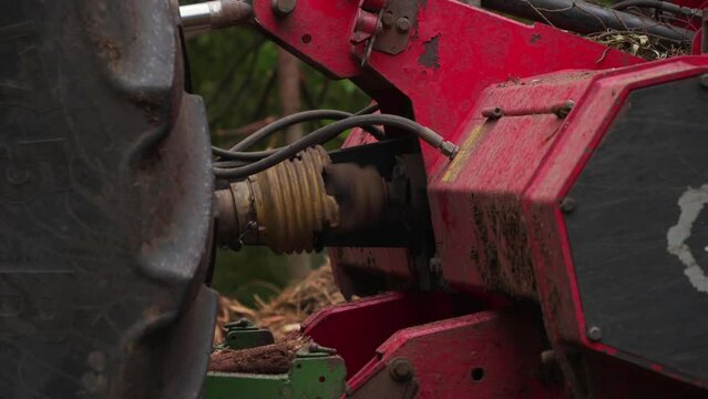 Close-up of the PTO shaft of a forestry mulcher at work in the forest. static shot