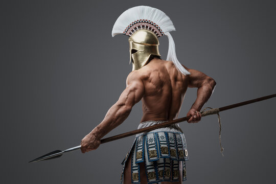 Studio shot of isolated on grey background spearman from antique greece.
