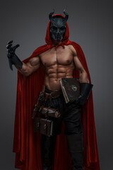 Obraz na płótnie Canvas Shot of handsome cultist in setting of dark fantasy with muscular body.
