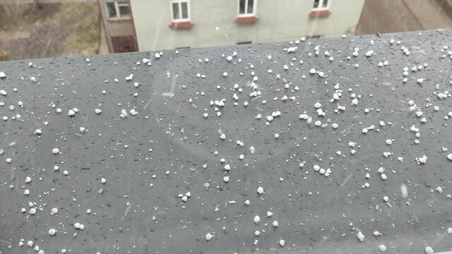 Snow graupel fall on the windowsill
