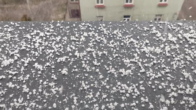 Snow graupel fall on the windowsill