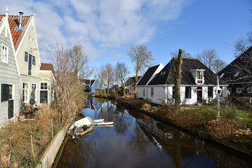 Fototapeta na wymiar Broek in Waterland, Netherlands. February 2023. The wooden facades and old houses in Broek in Waterland, Holland.