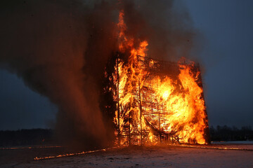 Fire. Russian Maslenitsa. Celebration of Maslenitsa 2023. Traditional national folk holiday in Nikola-Lenivets, Kaluga region, Russia. Russian landmark. Burning wooden castle