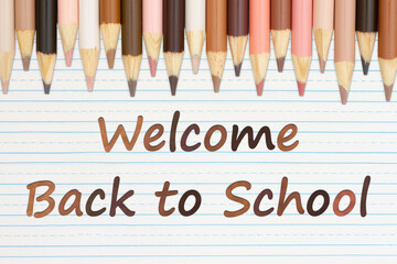 Welcome Back to School message with multiculture skin tone color pencils