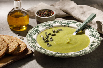 Creamy vegan broccoli soup in flowered rustic plate