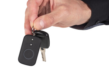 A businessman holding a car key on isolated background