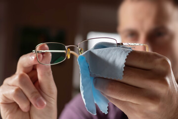 Close up hand of a man cleaning glasses