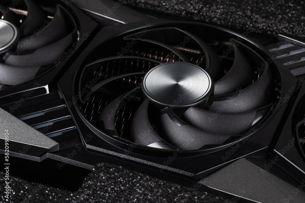 Poster video card with three coolers from the computer on a dark background.concept computer harware.