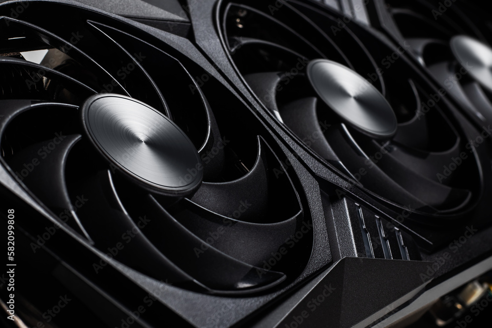 Poster video card with three coolers from the computer on a dark background.concept computer harware.