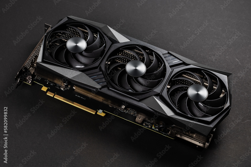 Poster video card with three coolers from the computer on a dark background.concept computer harware.