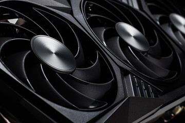 video card with three coolers from the computer on a dark background.concept computer harware.