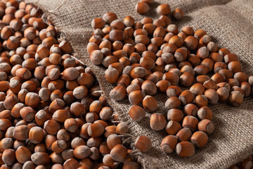 close up of hazelnuts on wooden table, top view